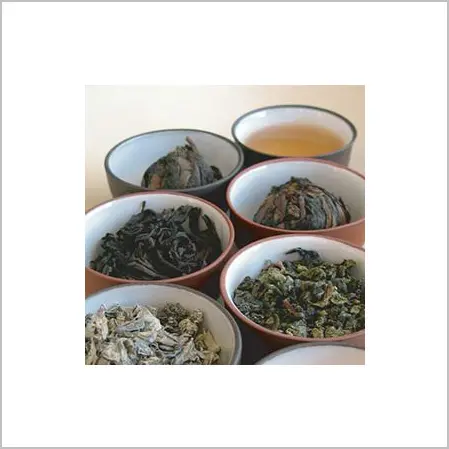 A table with bowls of different types of tea.