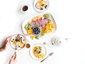 A table with plates of food and cups on it